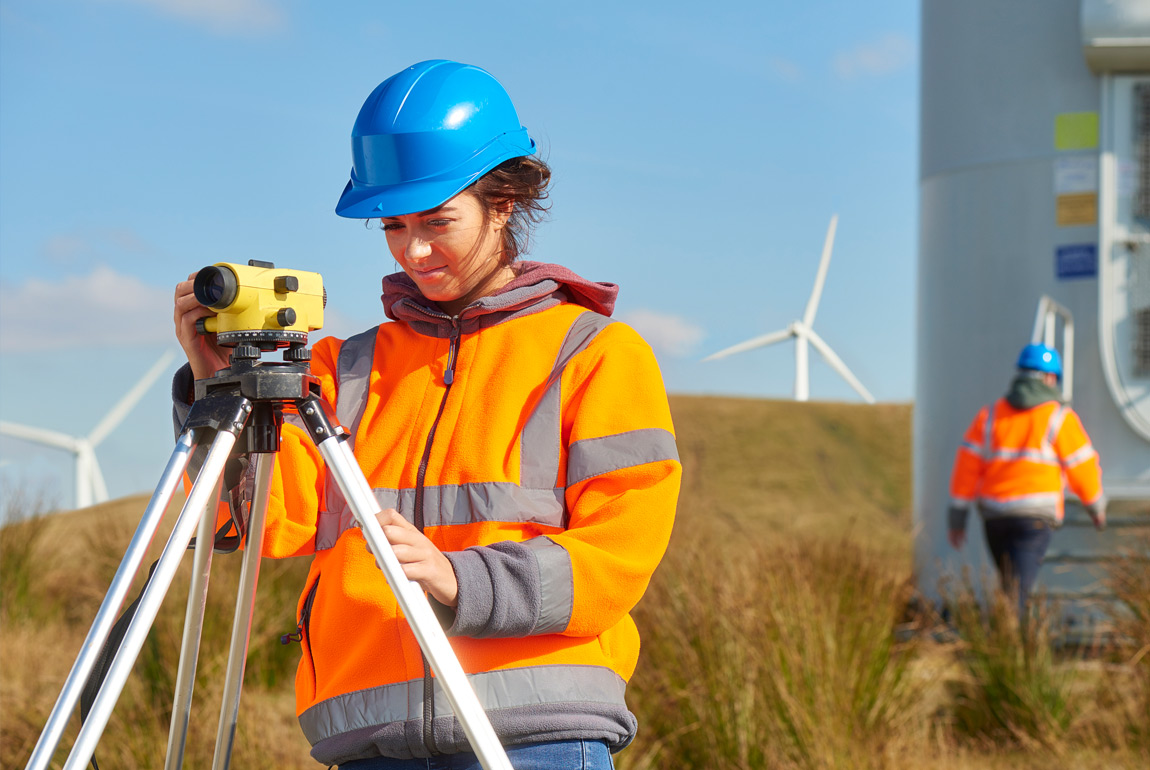 woman measuring levels on wind turbines